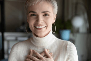 Woman with hands across chest